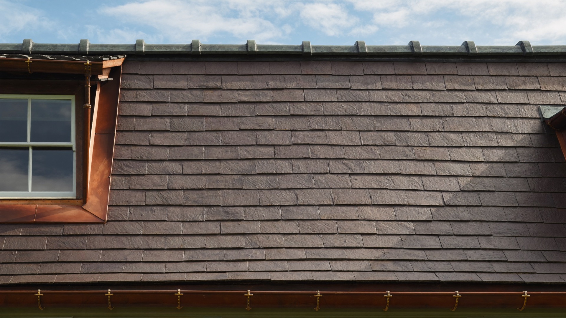 Schieferdach einer Gründerzeitvilla mit Kupferdetails und Gaube